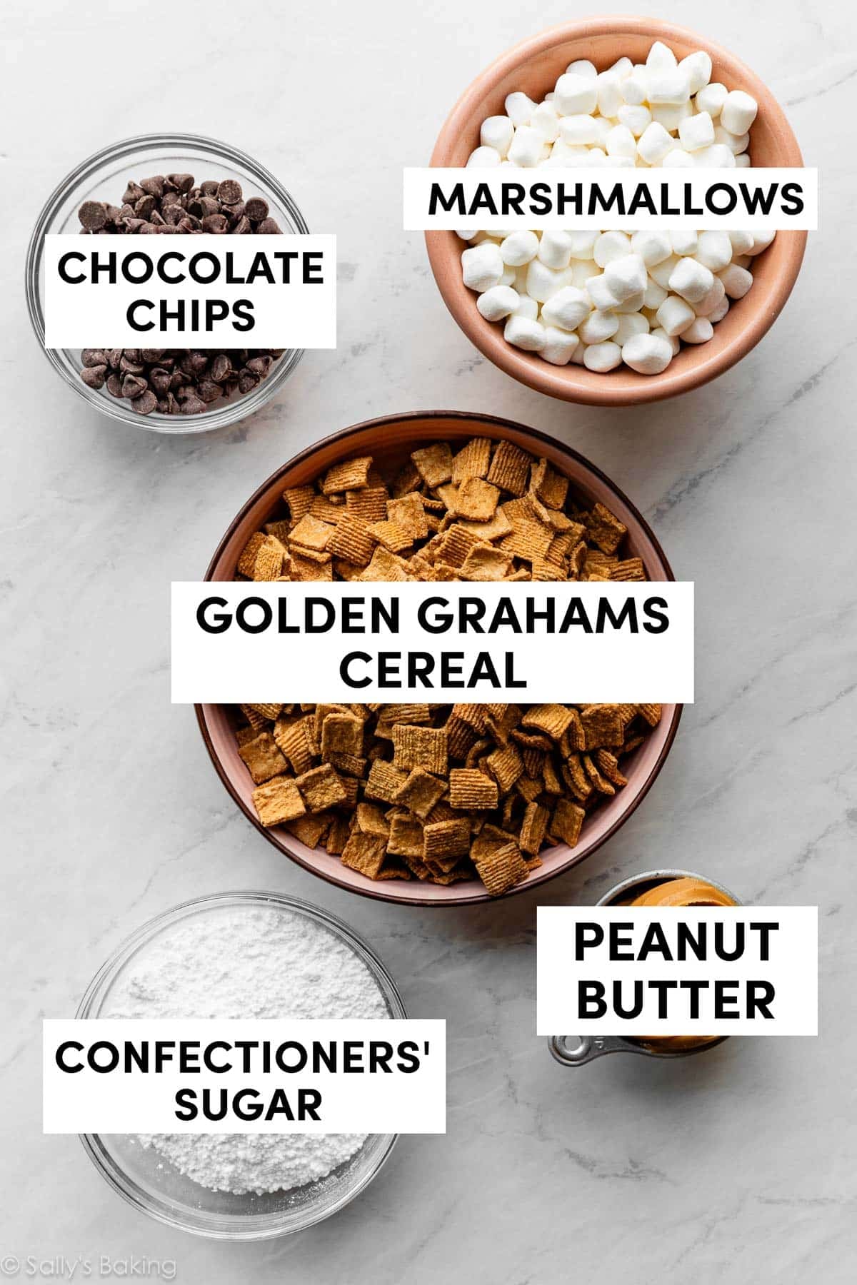 bowls of ingredients including golden grahams cereal, chocolate chips, and marshmallows.
