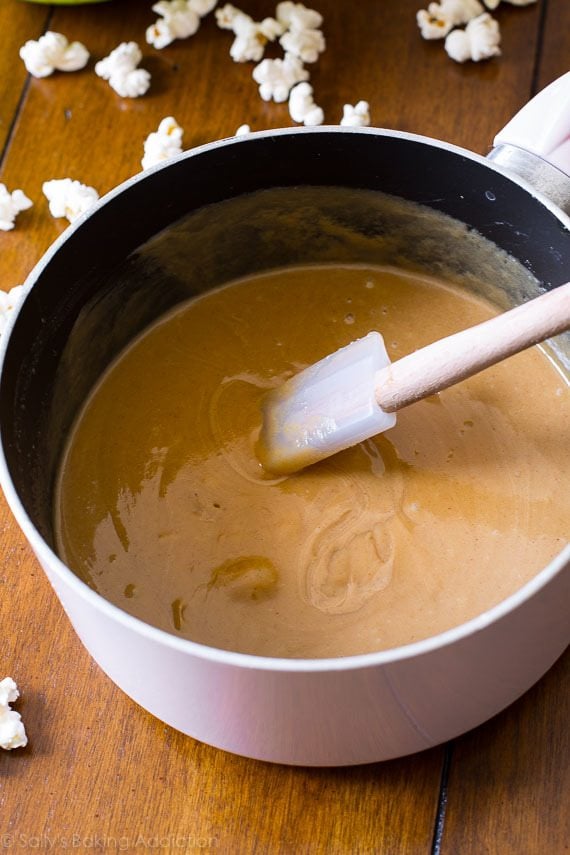 peanut butter honey mixture in a saucepan with a spatula