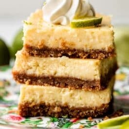 stack of 3 key lime pie bars on floral green plate.