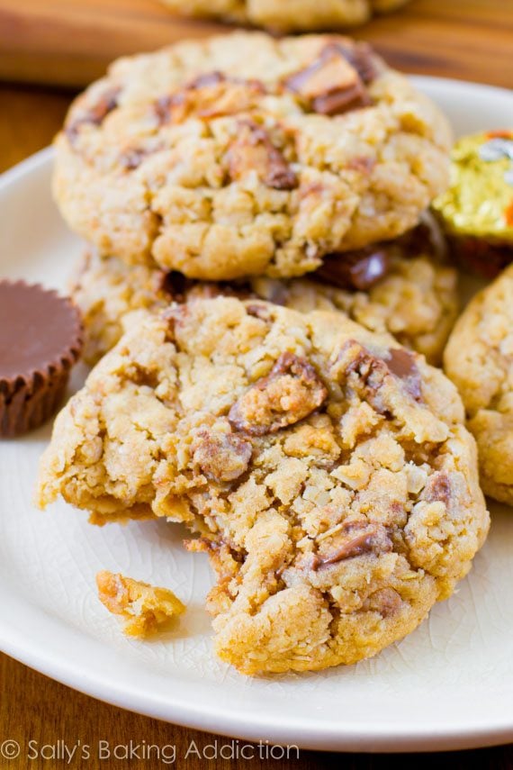 peanut butter cup oatmeal cookies on a white plate with a bite taken out of one