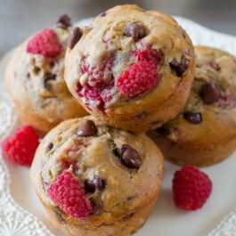 raspberry chocolate chip banana muffins on a white plate