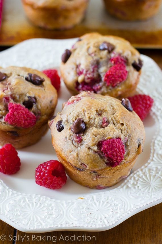 raspberry chocolate chip banana muffins on a white plate