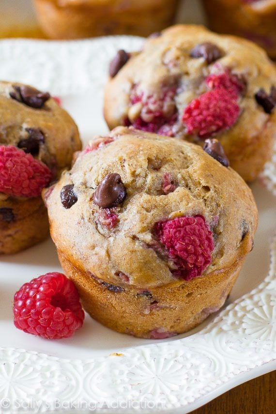 raspberry chocolate chip banana muffins on a white plate