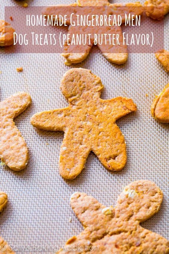 peanut butter dog treats shaped like gingerbread men on a silpat baking mat