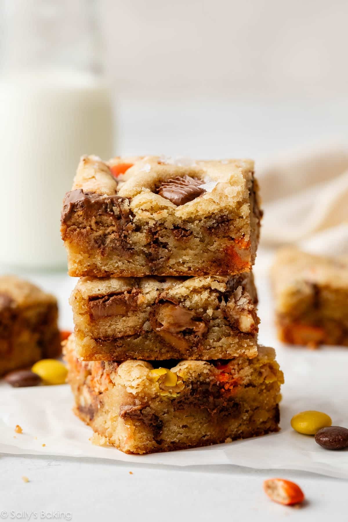 stack of 3 blondies with chopped candy bars inside.