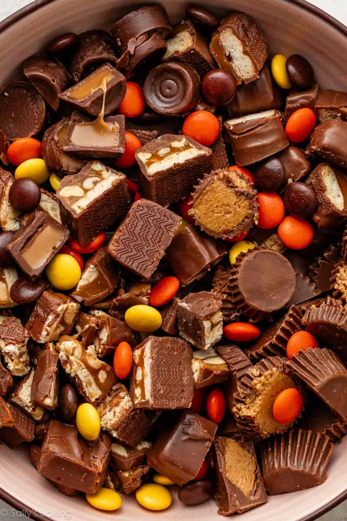 close up of Reese's Pieces, chopped Twix, Reese's, Snickers, and Rolos.
