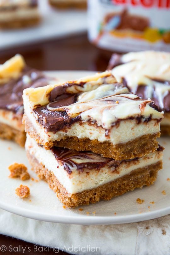 stack of Nutella swirl cheesecake bars on a white plate