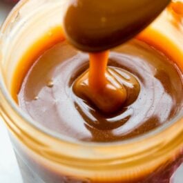 Salted caramel in a glass jar with a spoon