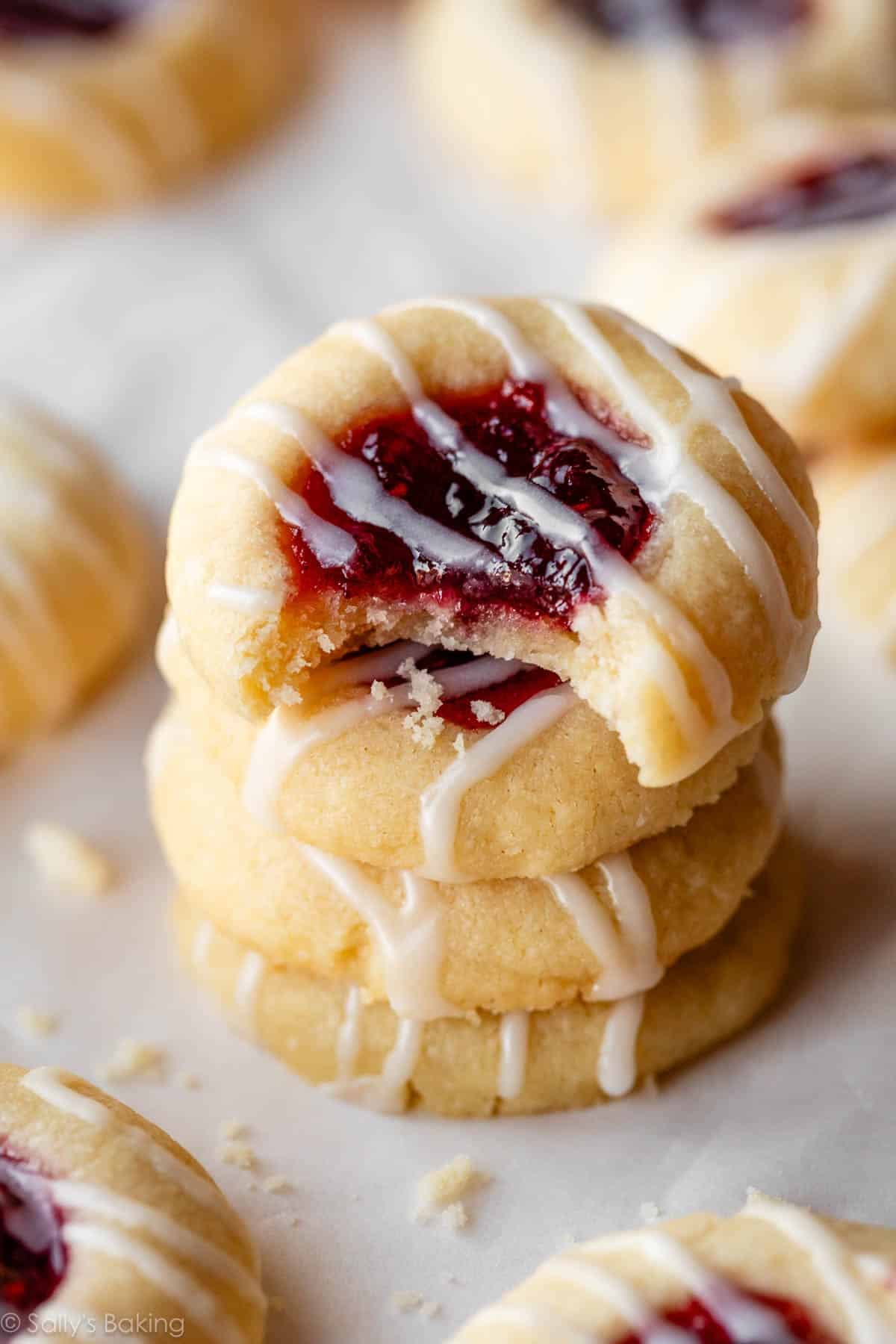 stack of 3 raspberry almond shortbread thumbprint cookies.