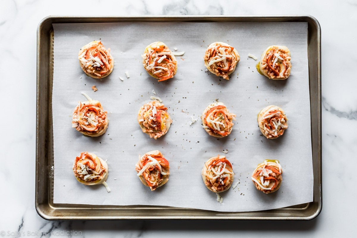 Pizza rolls dough on parchment lined baking sheet before baking