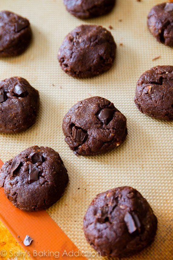 flourless dark chocolate almond butter cookie dough on a silpat baking mat before baking