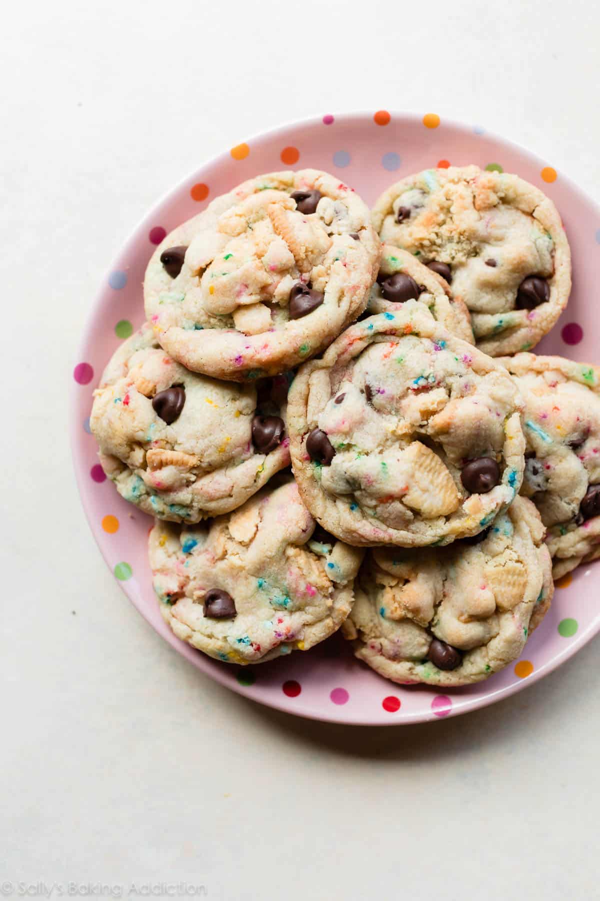 Cake Batter Oreo Cookies stacked on a pink polka dot plate