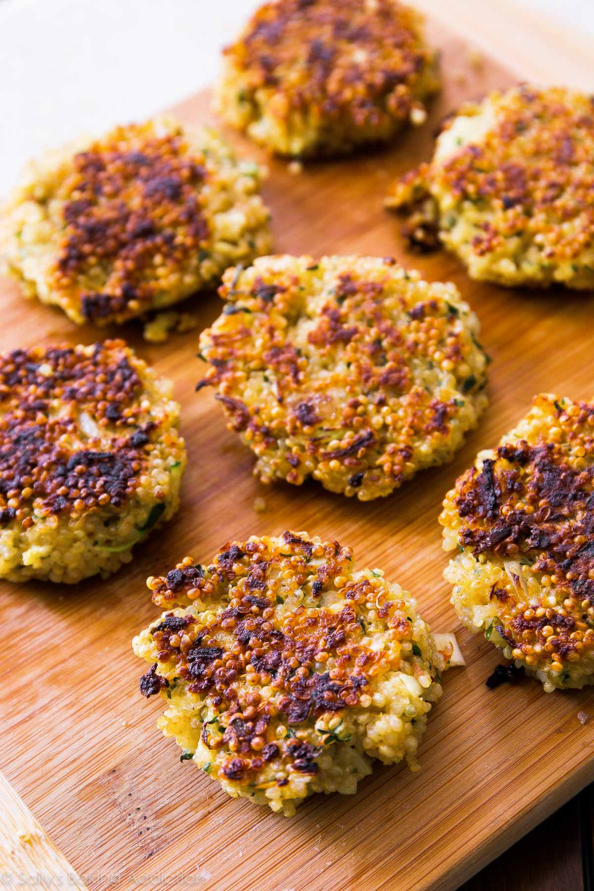 quinoa patties on a wood cutting board