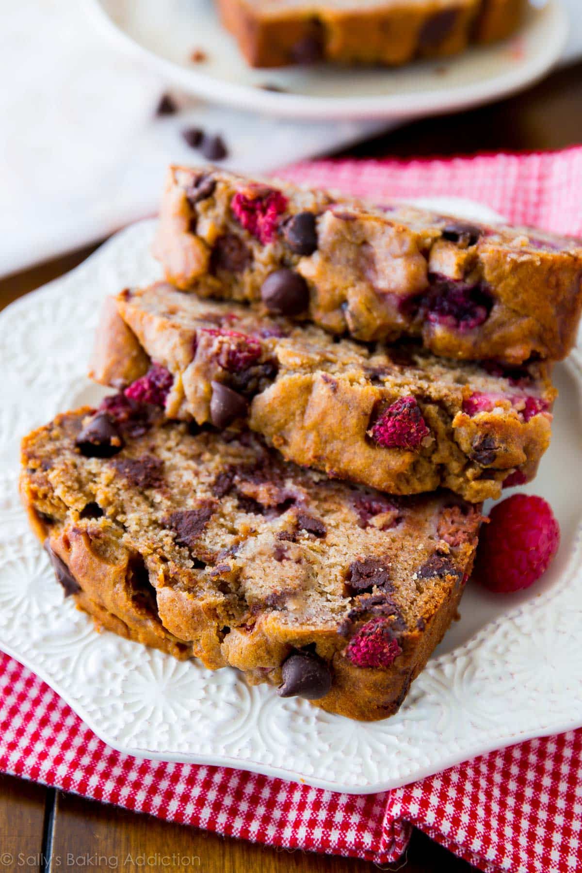 slices of raspberry dark chocolate banana bread on a white plate