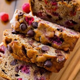 slices of raspberry dark chocolate banana bread on wood cutting board