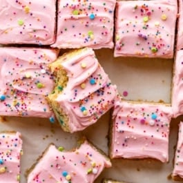 sugar cookie bars with frosting and sprinkles.