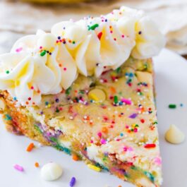 slice of funfetti sugar cookie cake on a white plate