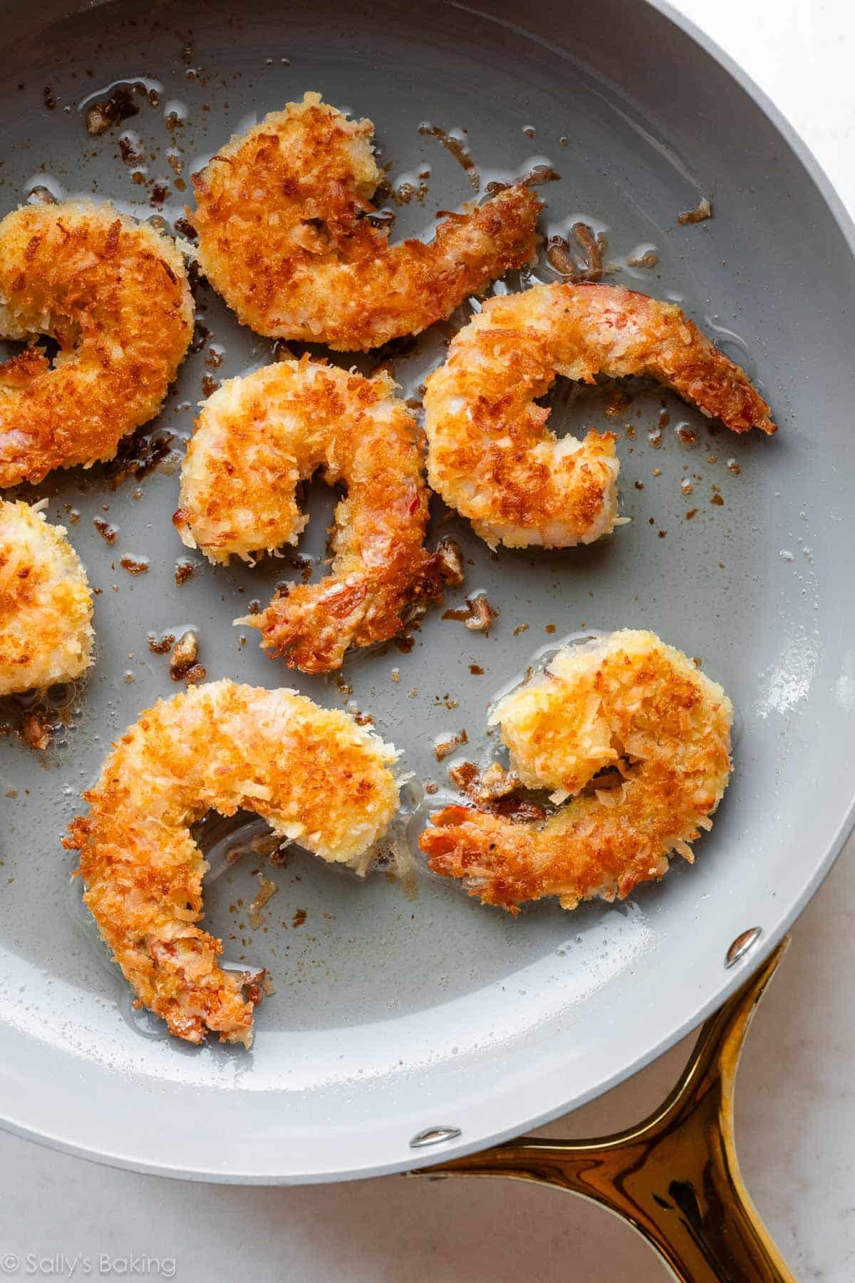 coconut shrimp in skillet.