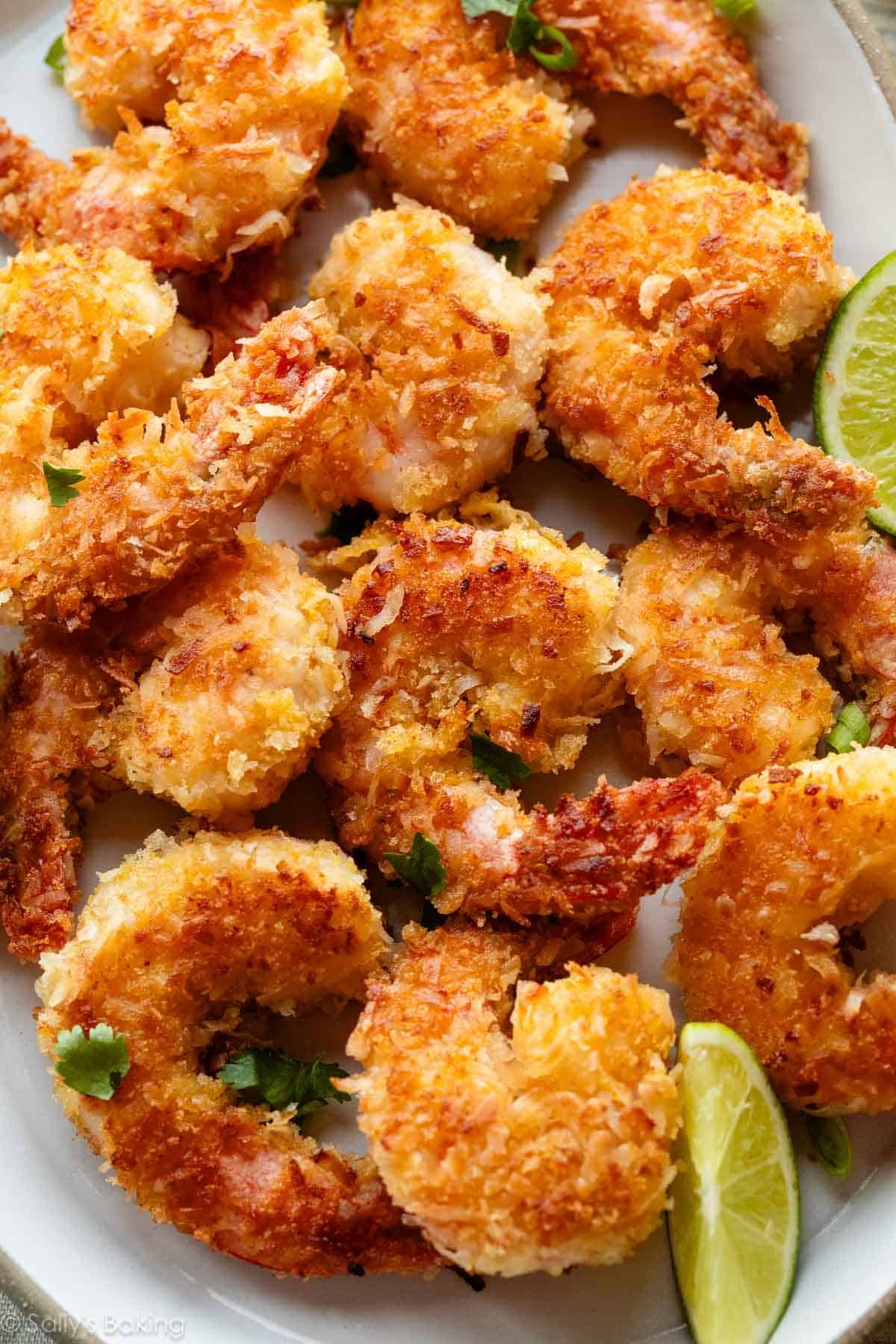 coconut shrimp with lime wedges and cilantro.