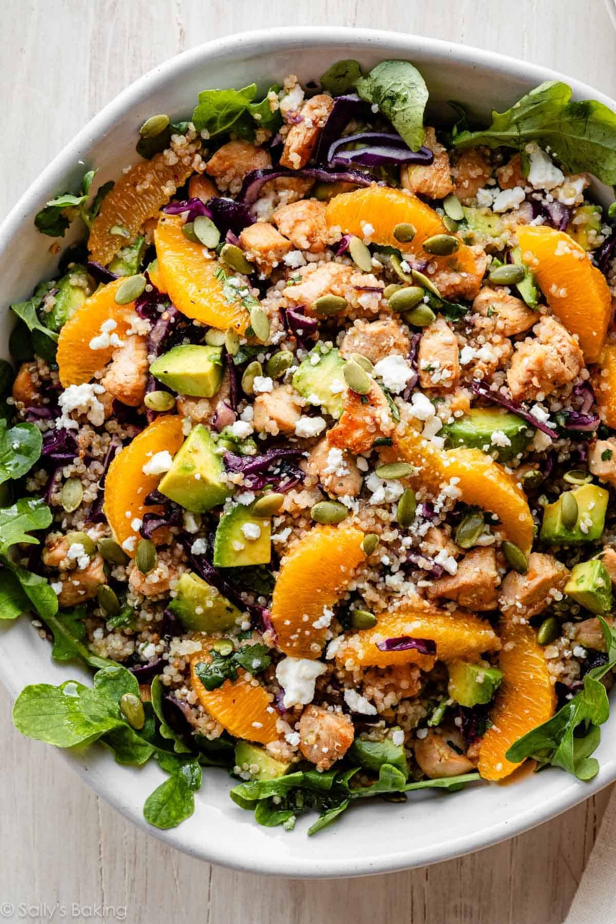 citrus chicken quinoa salad over arugula greens.
