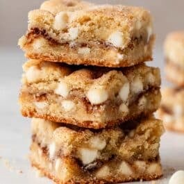 stack of 3 snickerdoodle blondies with white chocolate chips.