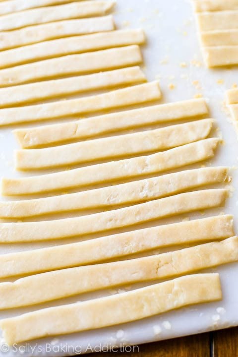 strips of pie dough on a white cutting board