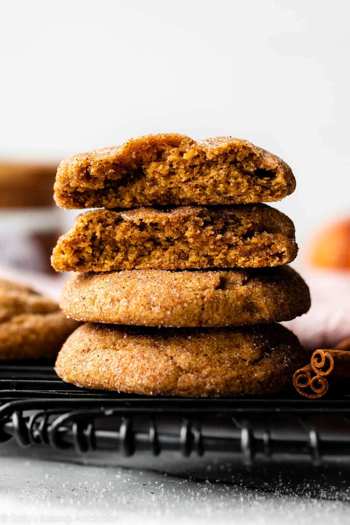 stack of pumpkin snickerdoodles on black cooling rack.