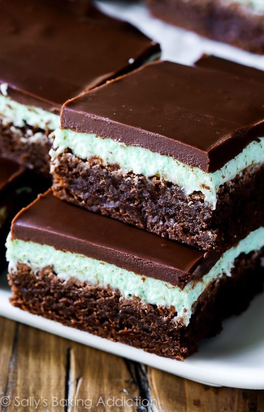 stack of mint chocolate brownies on a white serving tray