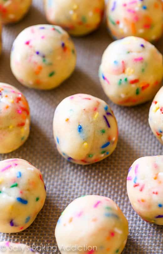 funfetti sugar cookie dough balls on a silpat baking mat