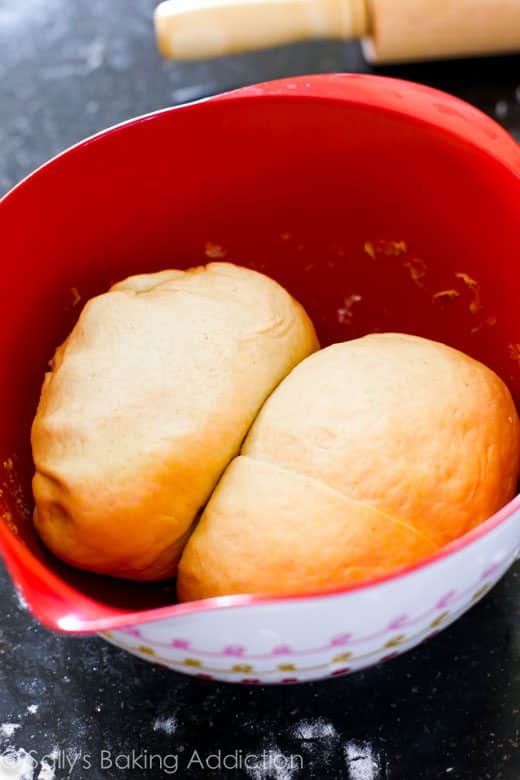 2 balls of deep dish pizza dough in a red bowl