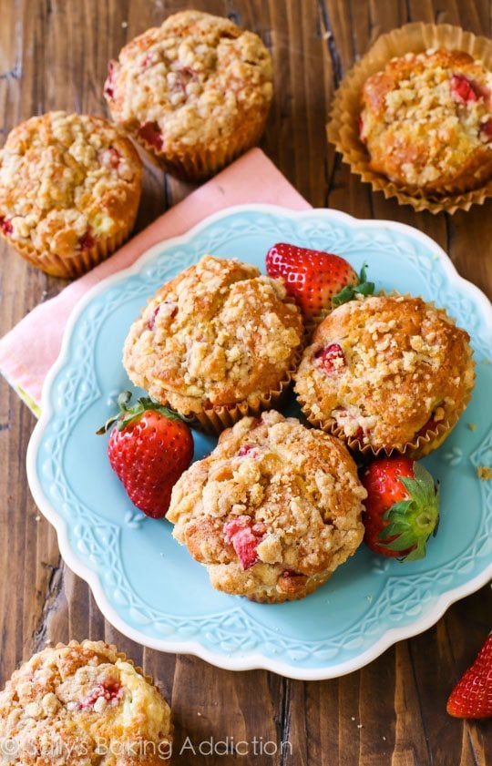 overhead image of strawberry cheesecake muffins on a blue plate