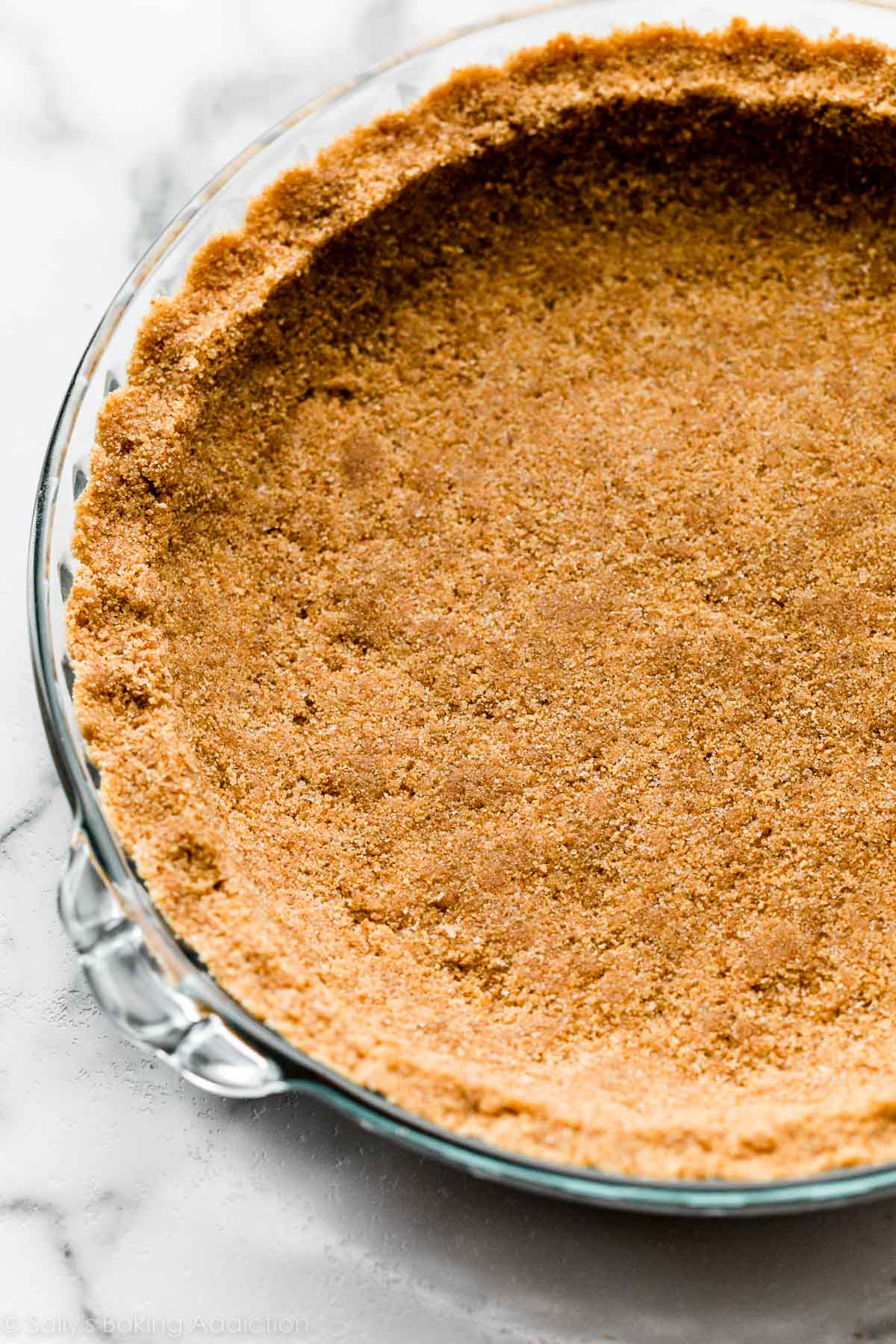 digestive biscuit pie crust pressed into glass pie dish.