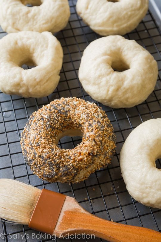 bagels after water bath on a cooling rack with spices