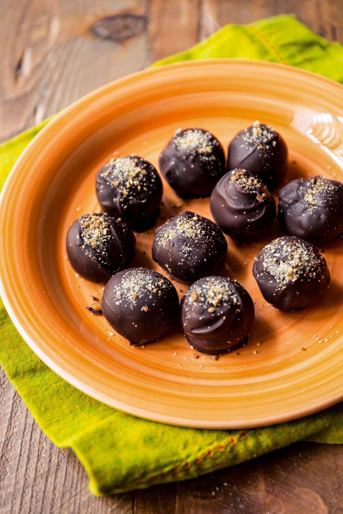 dark chocolate pumpkin spice truffles on an orange plate
