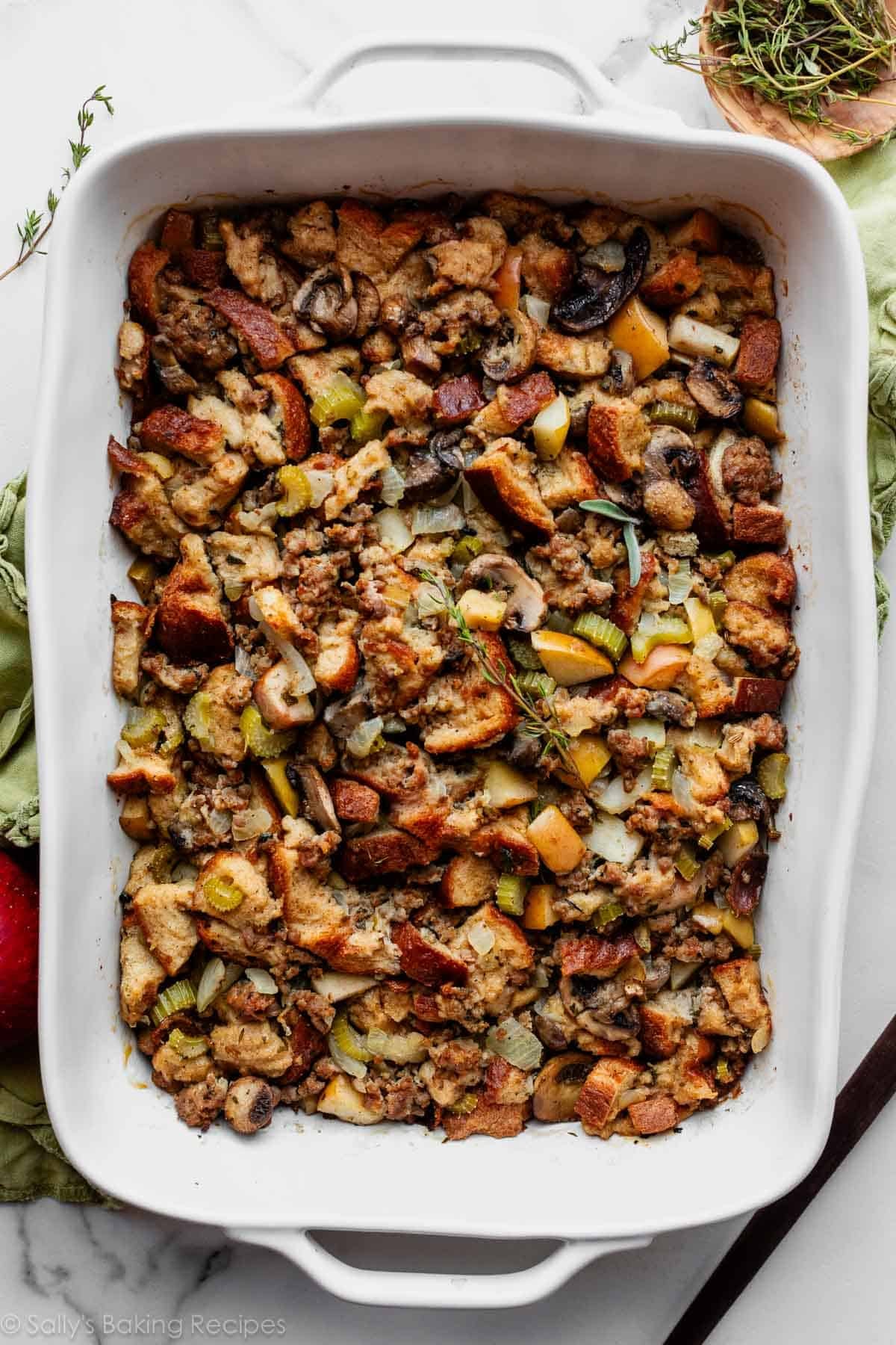 sausage herb Thanksgiving stuffing in a white baking dish.
