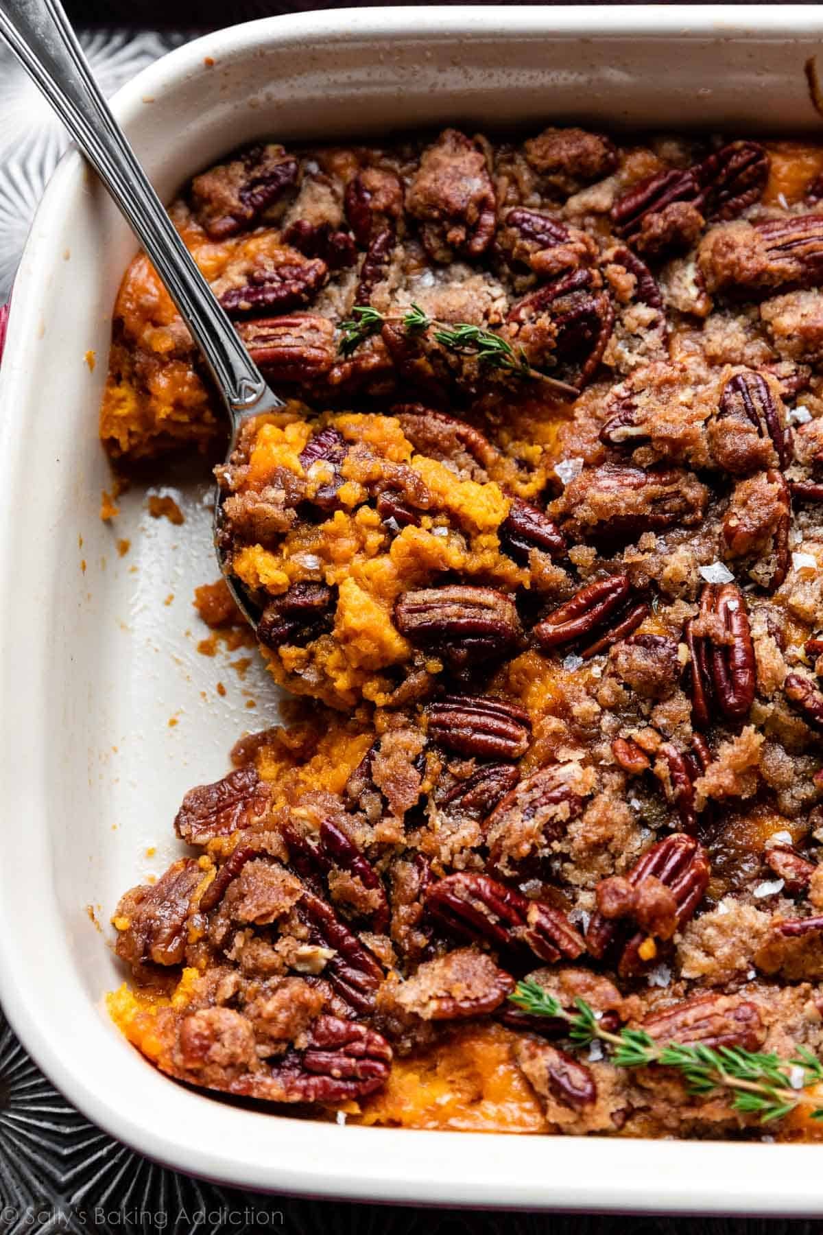 dish of sweet potato casserole with a serving spoon.