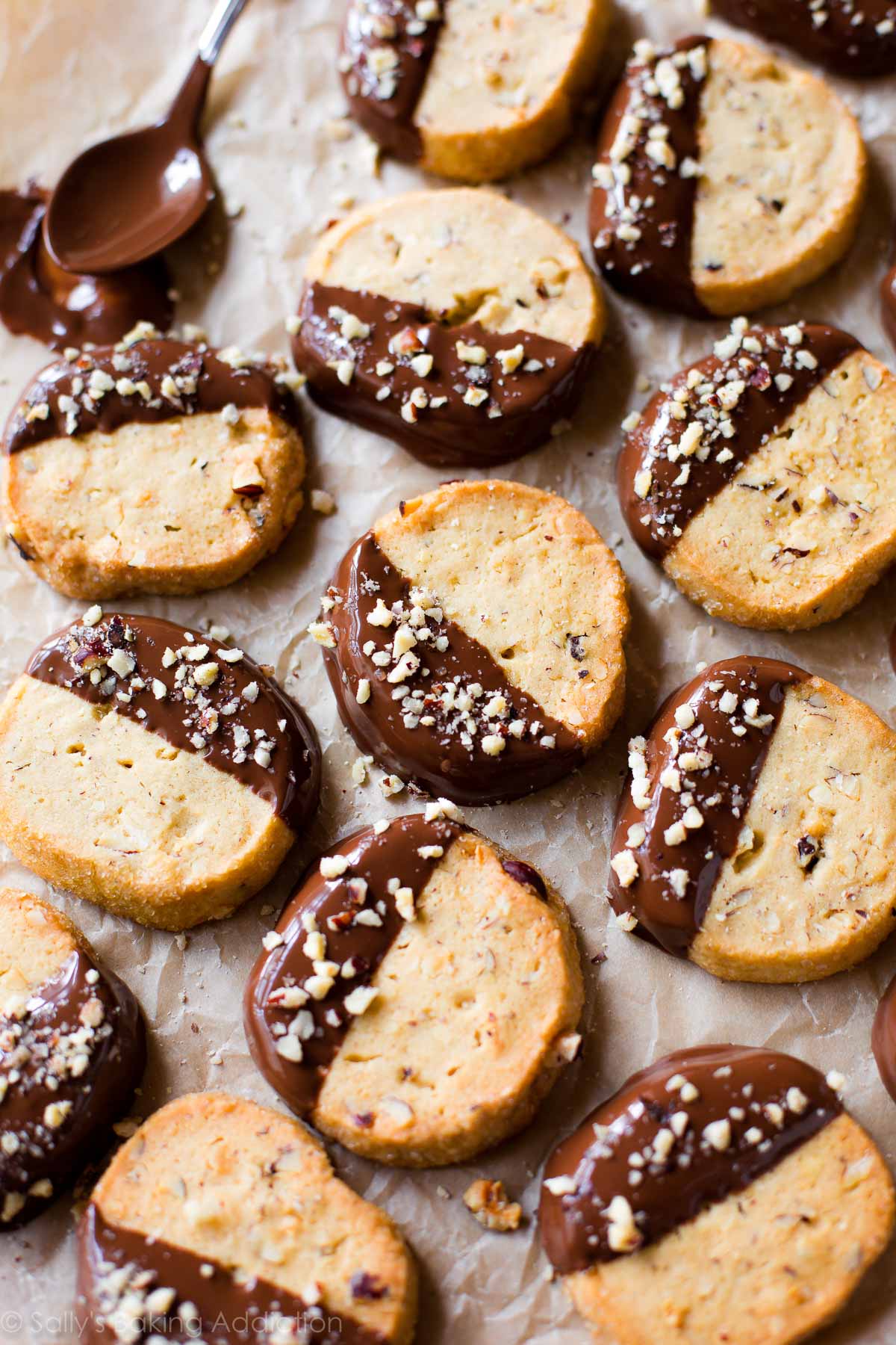 overhead image of toasted hazelnut slice and bake cookies with half of each cookie dipped in milk chocolate