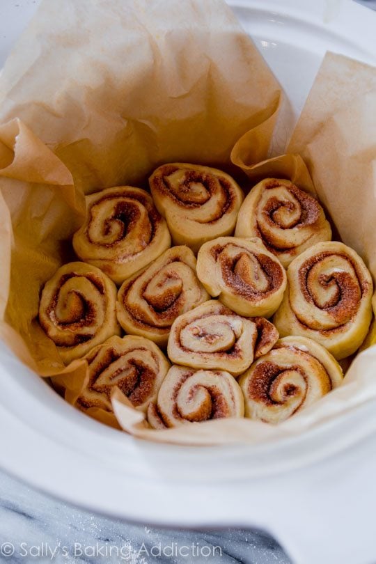 cinnamon rolls in a parchment paper lined slow cooker
