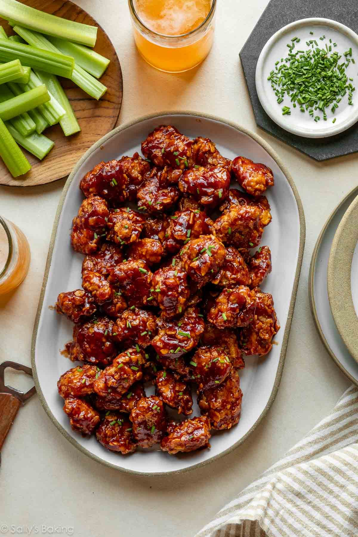 platter of honey bbq chicken bites with a plate of celery.