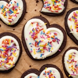cut-out chocolate sugar cookies with buttercream and sprinkles.