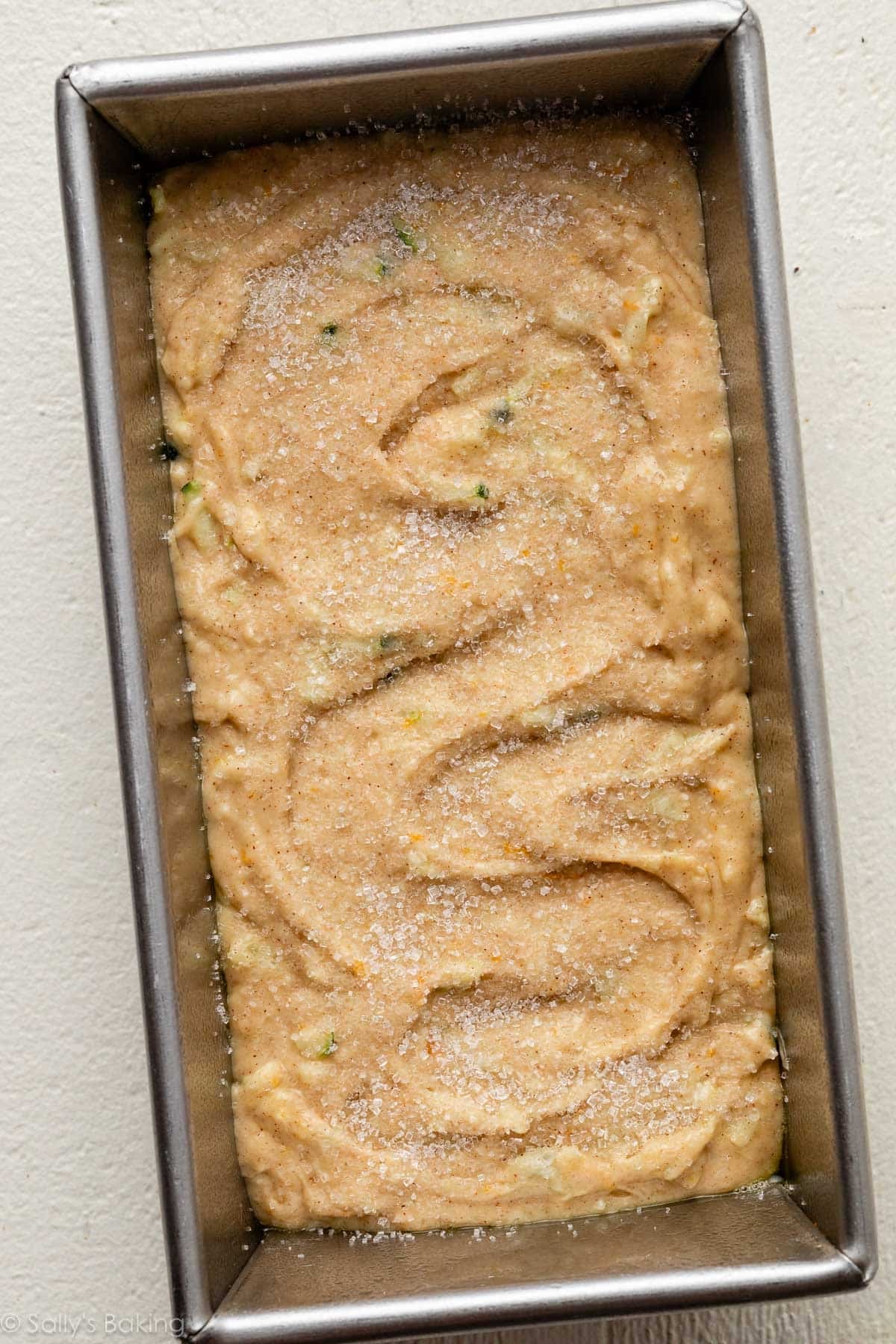 batter in loaf pan with a sprinkle of coarse sugar on top.