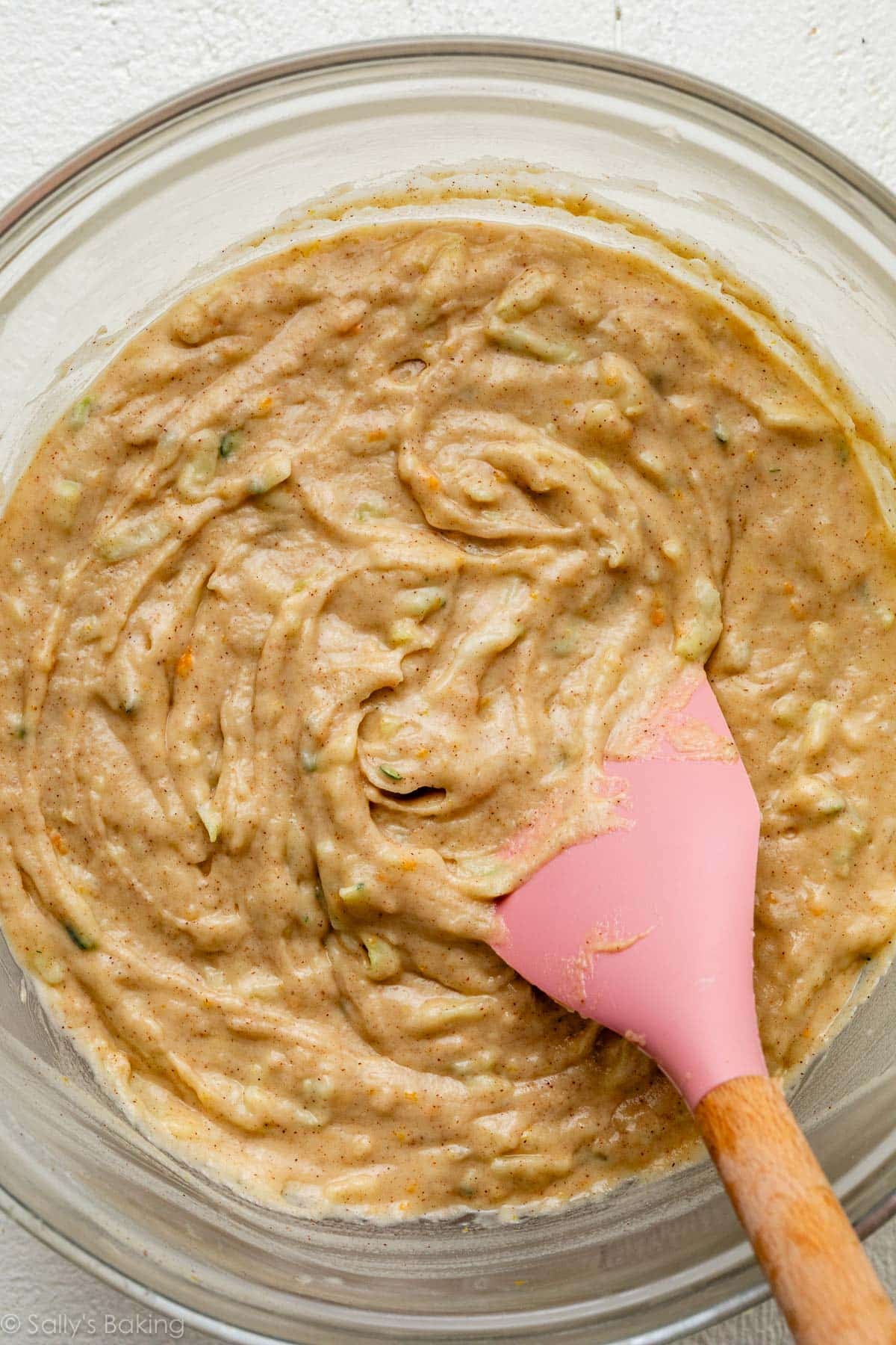 batter in glass bowl with pink spatula.