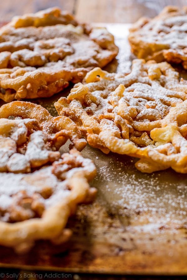 funnel cakes topped with confectioners' sugar