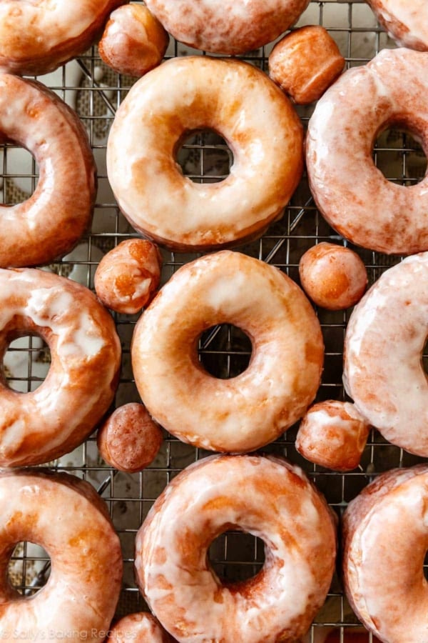glazed doughnuts on wire cooling rack on top of baking sheet.