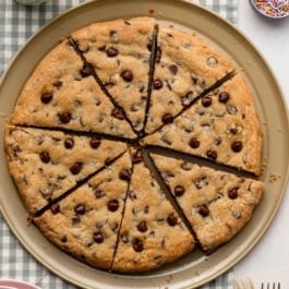 chocolate chip cookie pizza cut into slices.