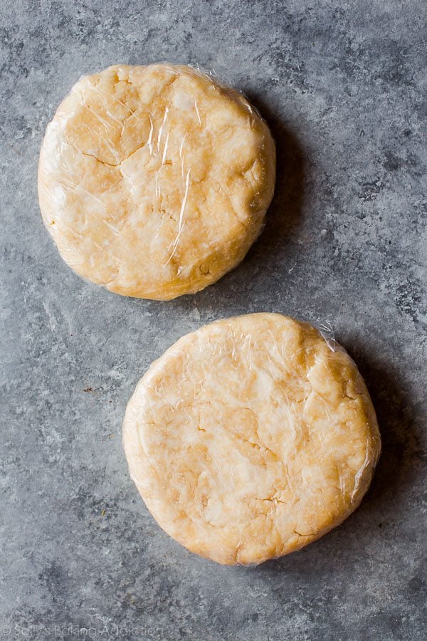 2 discs of pie dough wrapped in plastic wrap