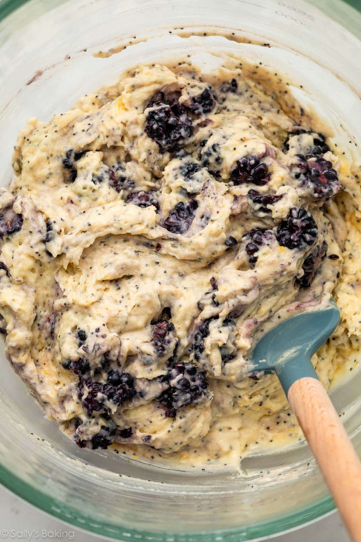 batter with fresh blackberries in glass bowl.
