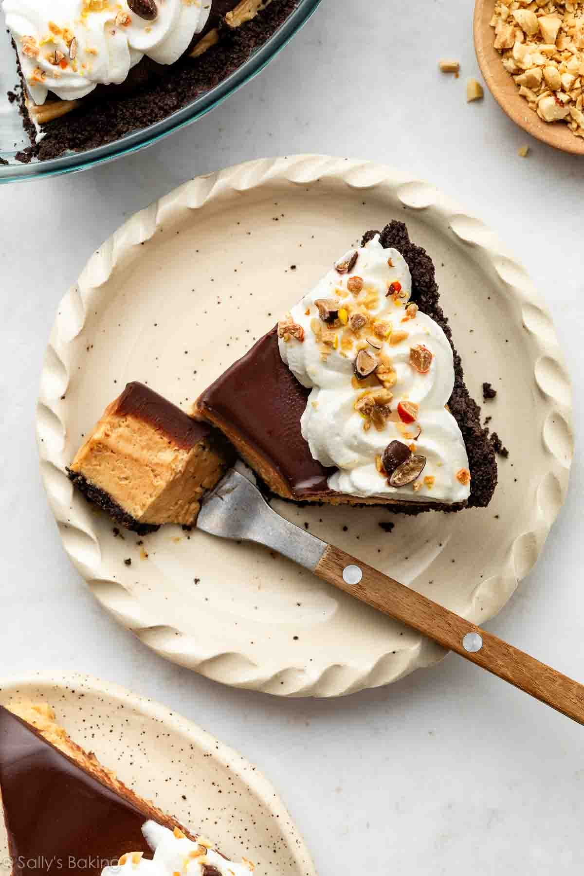 slice of peanut butter pie topped with whipped cream.