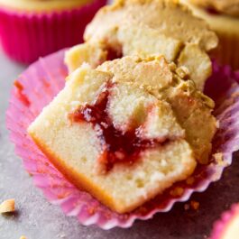 peanut butter and jelly cupcake cut in half showing jam filling