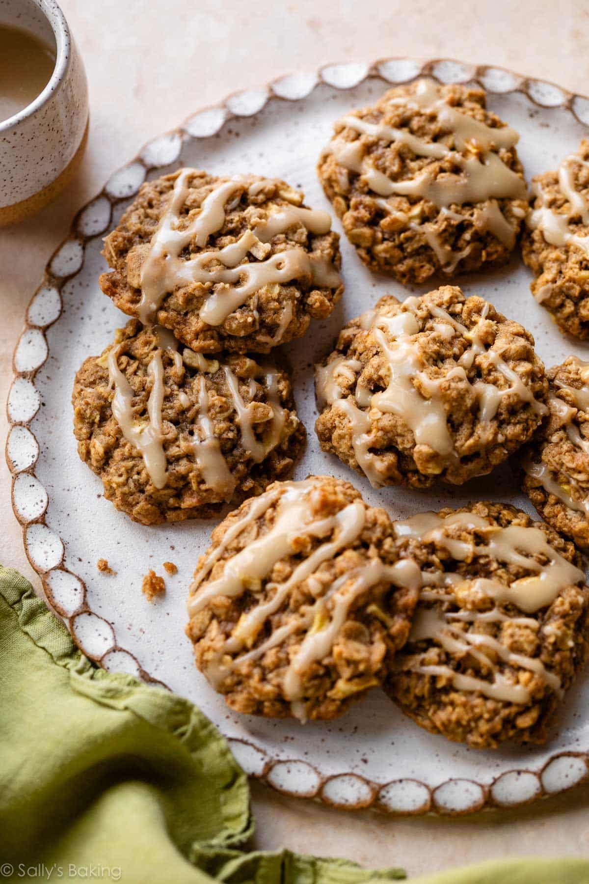 plate of apple cinnamon oatmeal cookies with maple icing on top.
